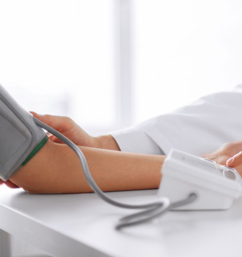 Patient receiving a blood pressure screening from a professional pharmacist at Walsh's Pharmacy.