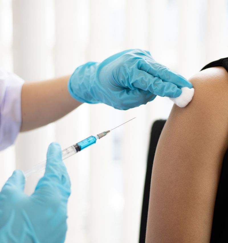 Patient receiving a vaccine as part of Walsh's Pharmacy comprehensive immunisation services.