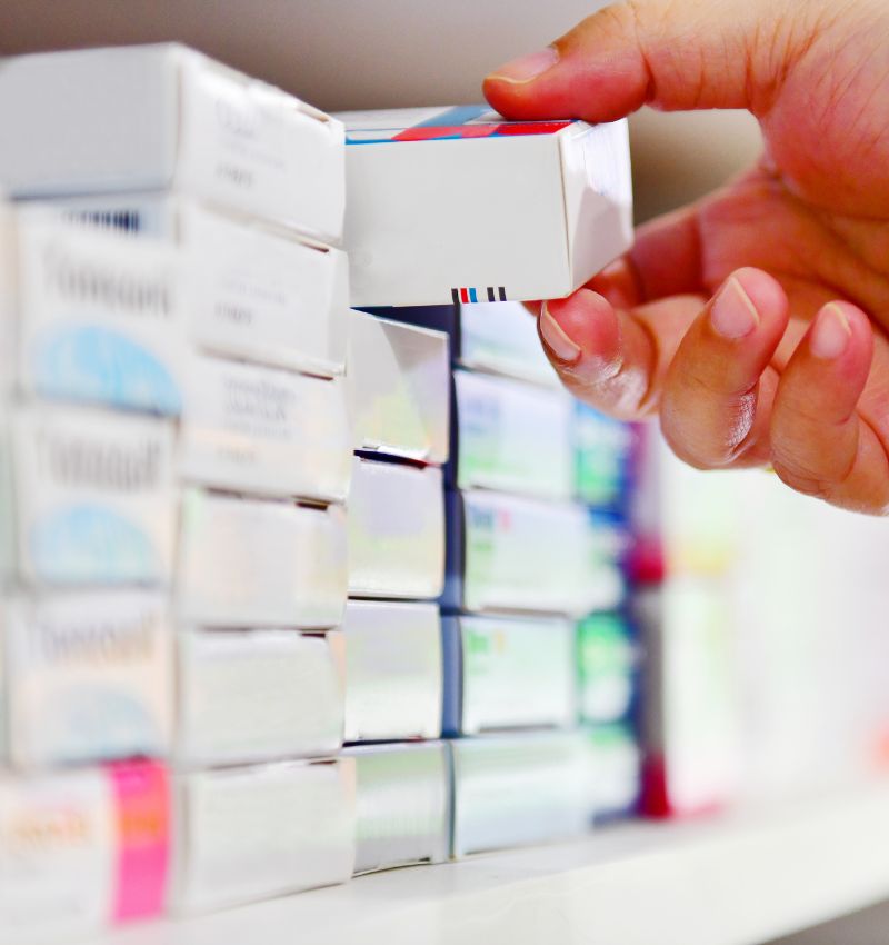 Pharmacist providing prescription consultation to patient at Walsh's Pharmacy.